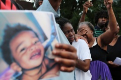 Willisha Jones, center, mother of 18-month-old Jesstin Sellers, is comforted by Pastor Michael Lewis of Mt. Nebo Baptist Church during a candlelight vigil for the toddler in Southeast Atlanta. At right is Sellers' great grandmother Mabel Russell.