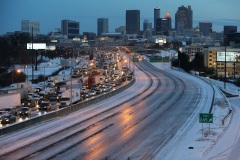 As dawn breaks following the first winter storm of the 2014, the Connector Southbound is clogged with cars and trucks that were stuck overnight while trying to leave Downtown Atlanta.